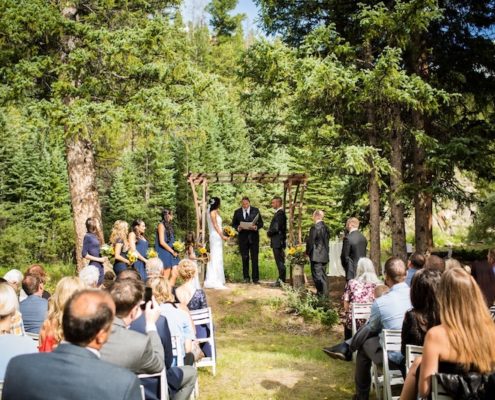 Rustic Iron Wedding Arbor rental & White Garden Resin Ceremony Chairs