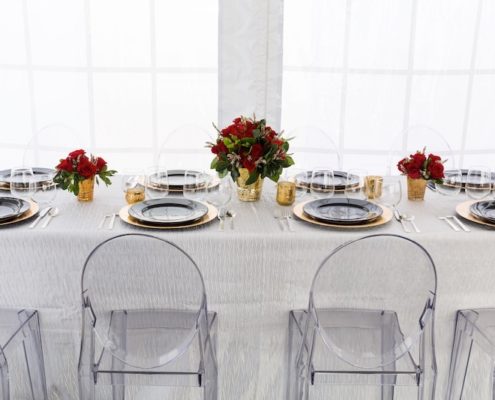 Modern Tablescape With Ghost Chairs, Round Black China & Stemless Wine Glasses & charger rentals for wedding