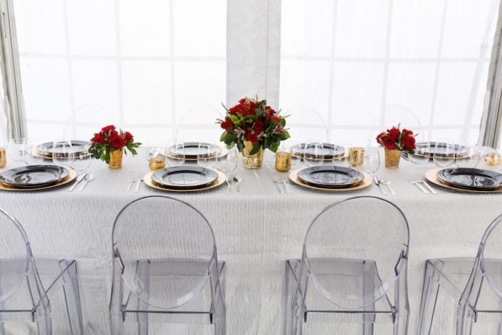 Modern Tablescape With Ghost Chairs, Round Black China & Stemless Wine Glasses & charger rentals for wedding