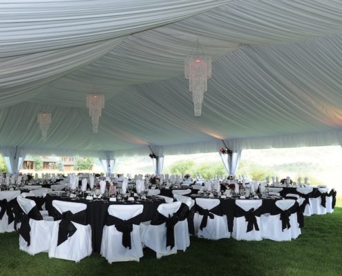 event rentals near Denver -Fabric Lined Tent With wedding chandelier rental & Chair Covers With Sashes