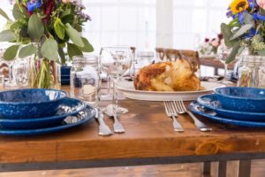 Farm Table With Hammered Silverware, Mason Jar Glasses & Western Blue Plates