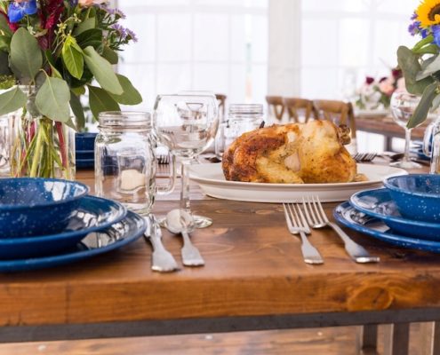 Farm Table With Hammered Silverware, Mason Jar Glasses & Western Blue Plates
