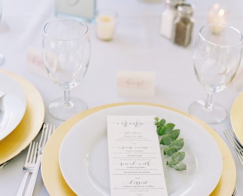 Place Setting With Deco Silverware, Napa Glassware, White wedding china rental & Gold chargers wedding in Vail, Colorado