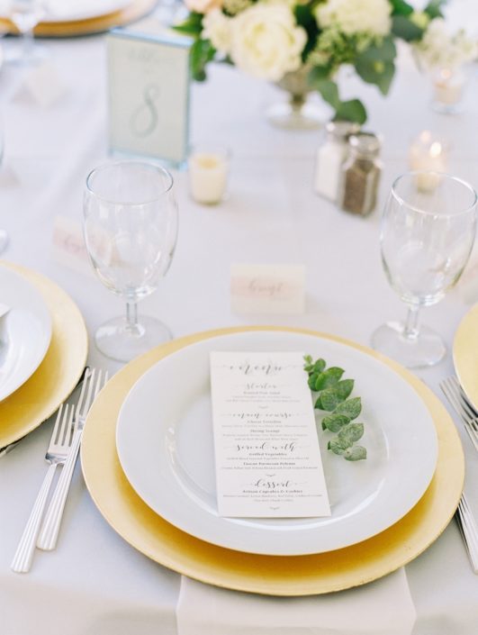 Place Setting With Deco Silverware, Napa Glassware, White wedding china rental & Gold chargers wedding in Vail, Colorado
