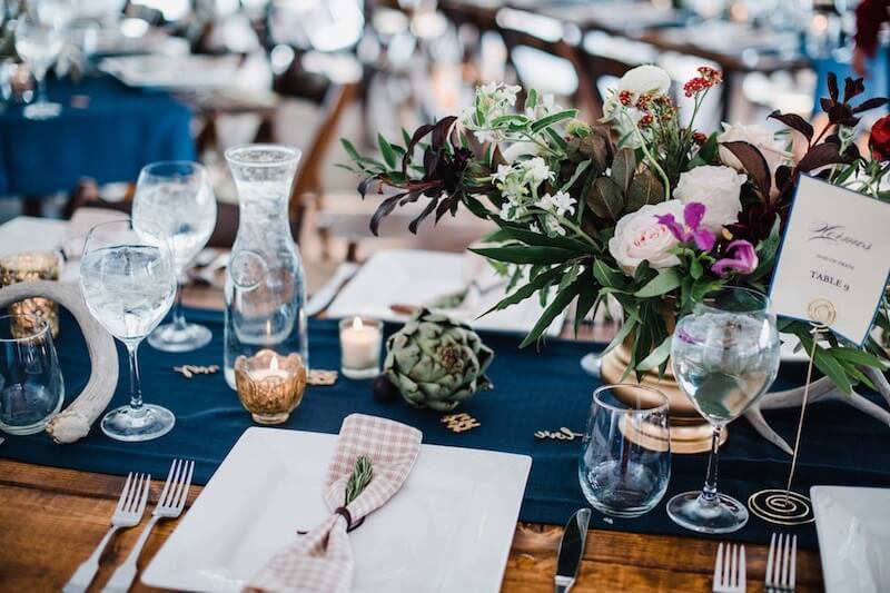 Farm Table With Square Plates, Hammered Flatware, Water Carafs & Stemless Wine Glasses