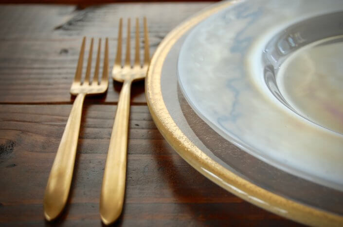 gold flatware rental and gold rimmed wedding chargers with luster plates