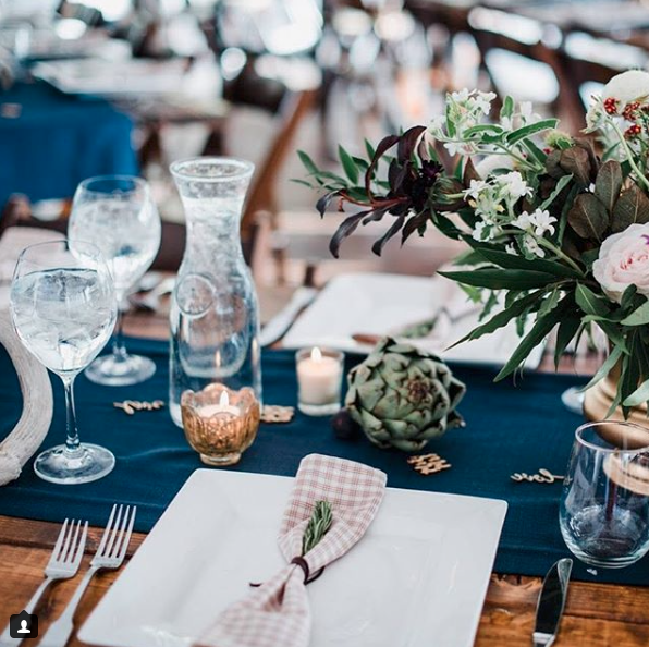 Table setting with square plates and blue table runner