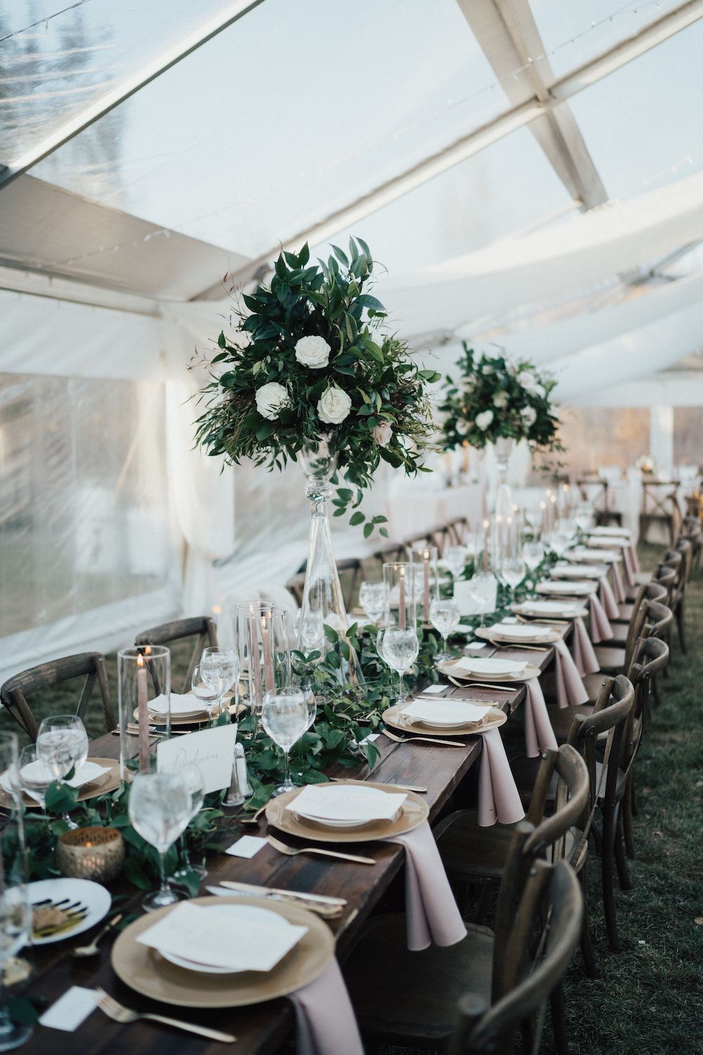 elegant rustic farm tables in tented wedding