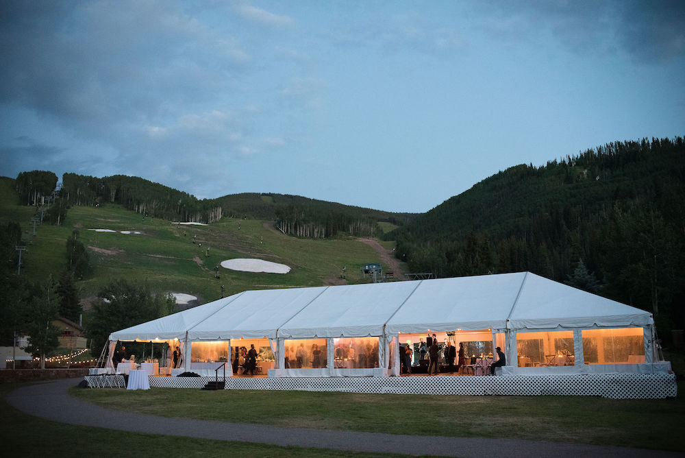 Larkspur wedding tent at dusk with window sidewalls