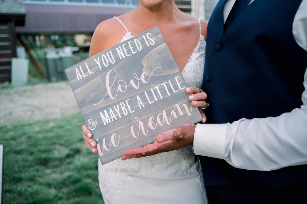 Colorado bride and groom with wedding sign - Danielle Roth photo