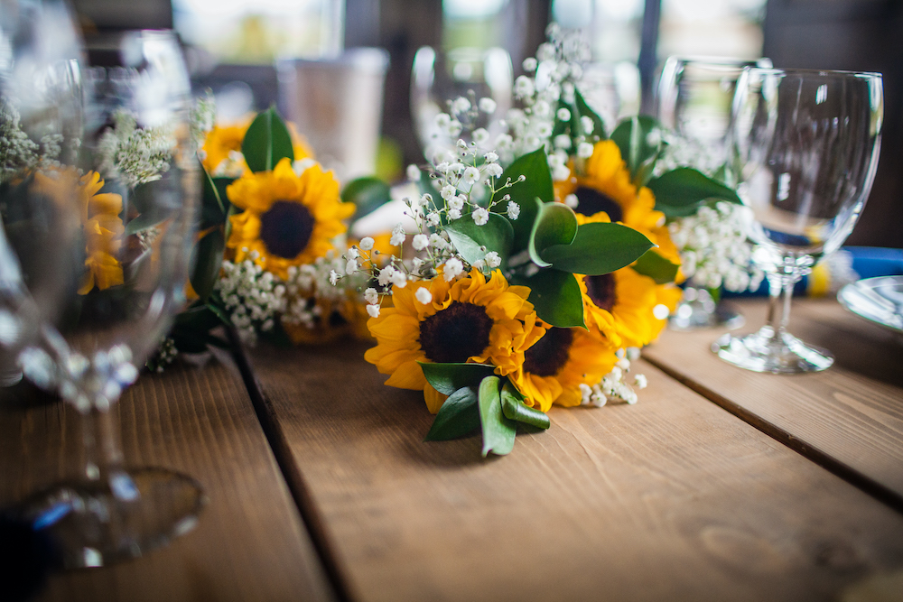 Sunflowers on farm table at Colorado wedding