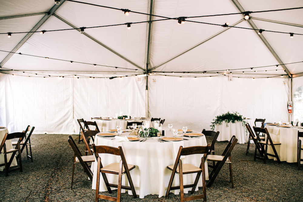 Wedding tent with mahogany chairs in Colorado