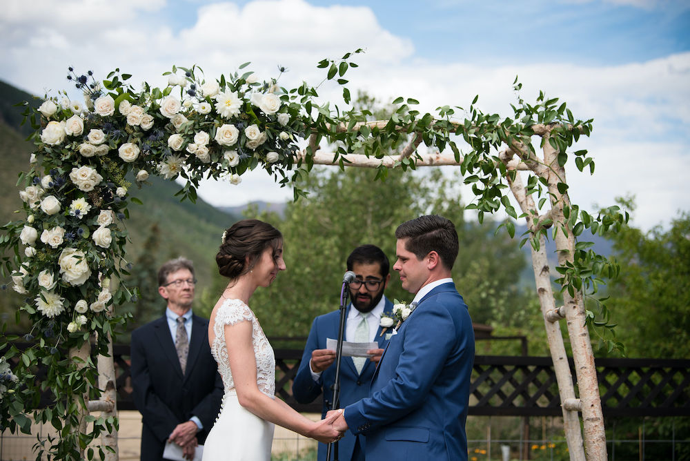 Colorado wedding ceremony bride and groom with arbor