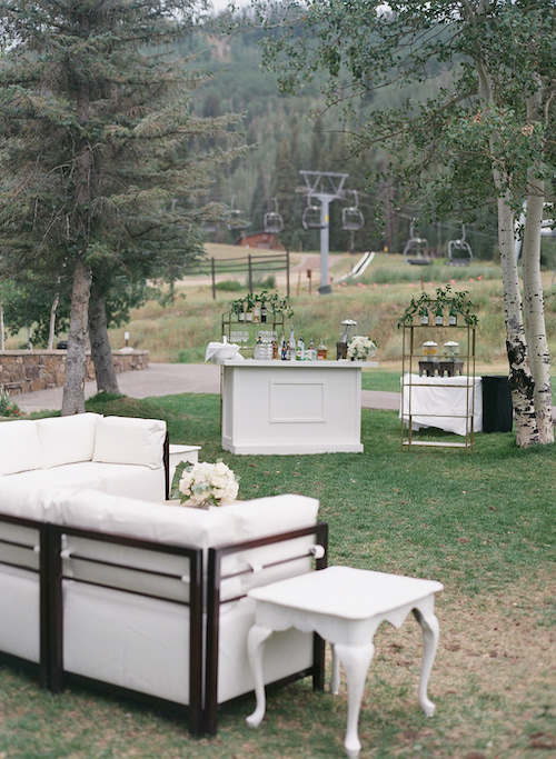 white lounge area and bar for Colorado mountain wedding outdoors