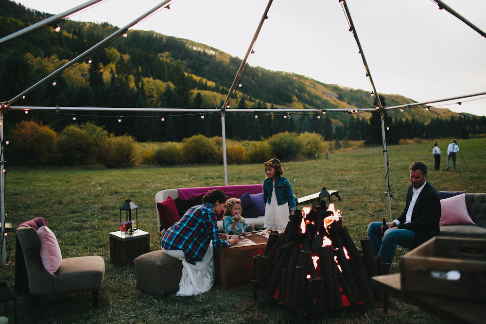 Outdoor boho lounge area with fire pit for outdoor Colorado wedding