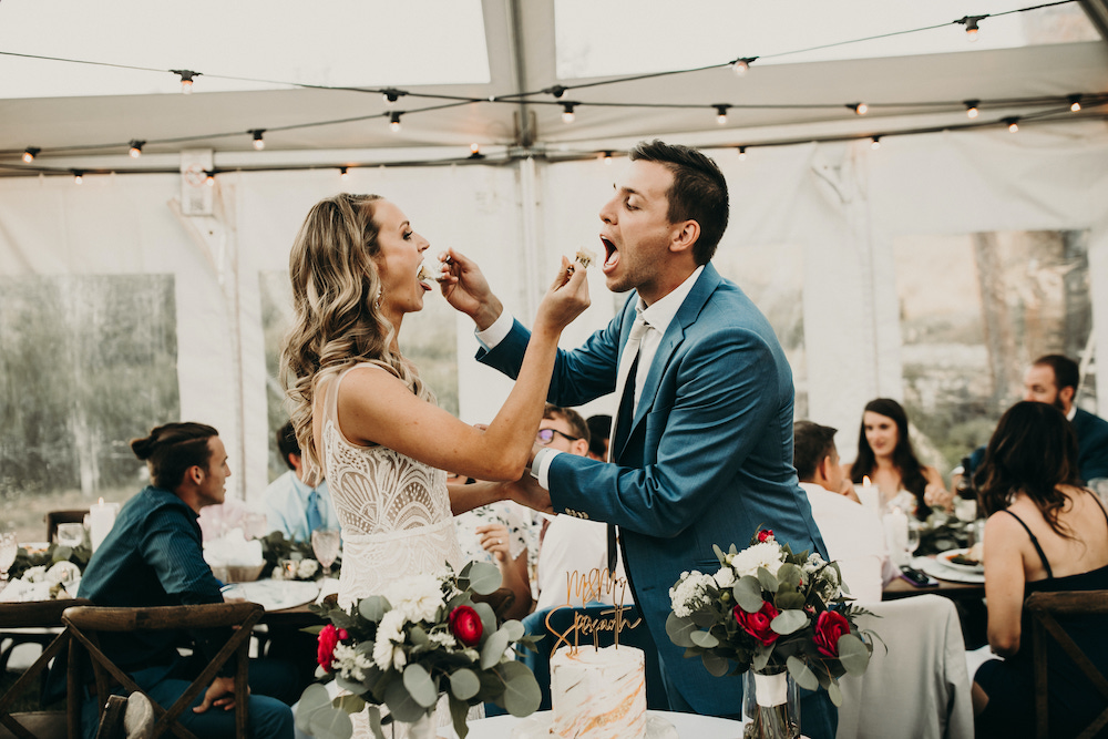 Breckenridge bride and groom eating cake