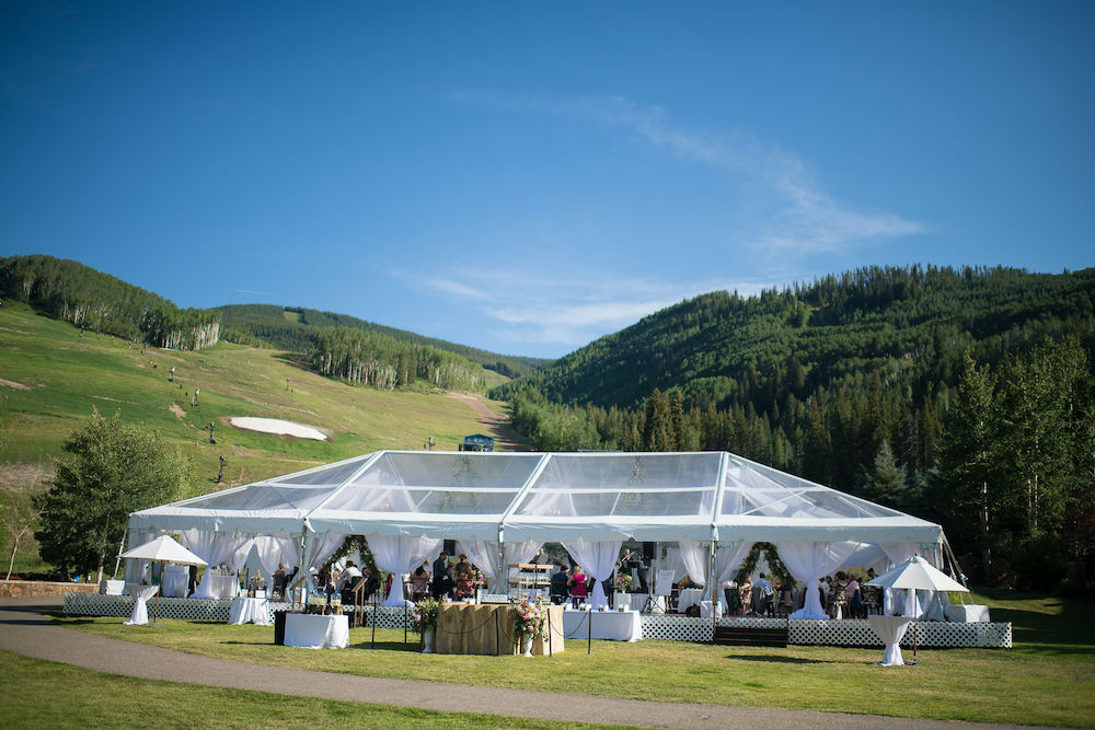 Clear wedding tent at Larkspur Vail on lawn with cocktail hour